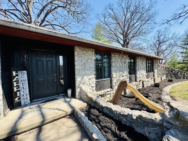 view of exterior entry with stone siding