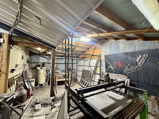 miscellaneous room featuring metal wall and unfinished concrete flooring