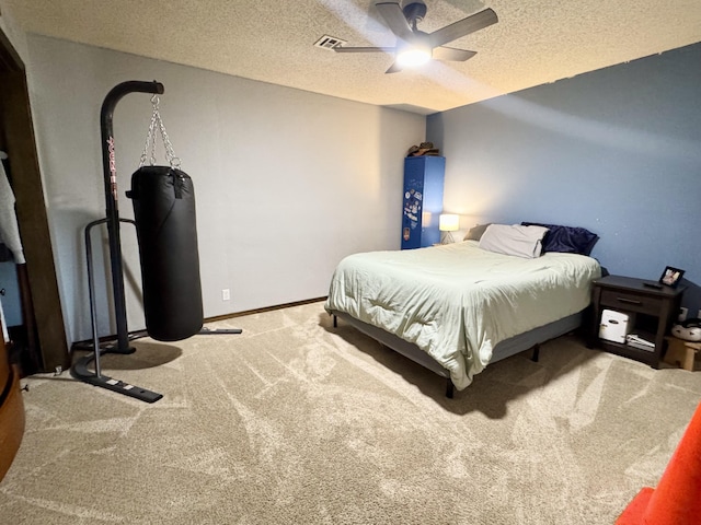 carpeted bedroom featuring baseboards, a textured ceiling, and a ceiling fan