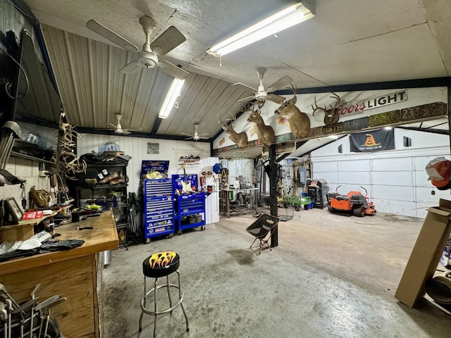 garage with a workshop area and ceiling fan