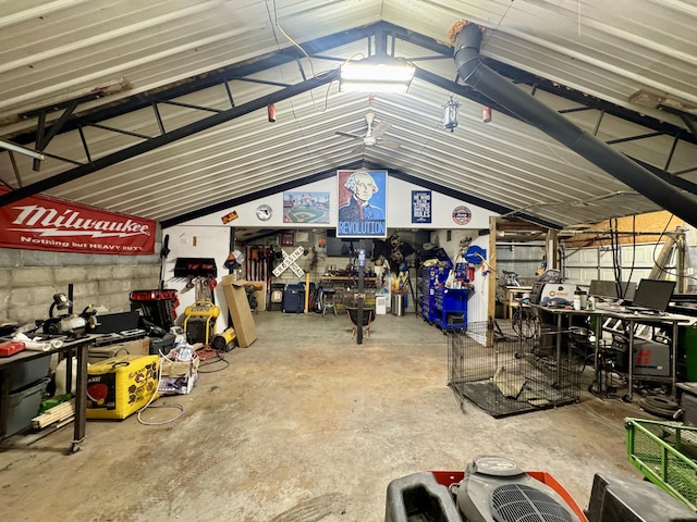 garage featuring concrete block wall and a workshop area