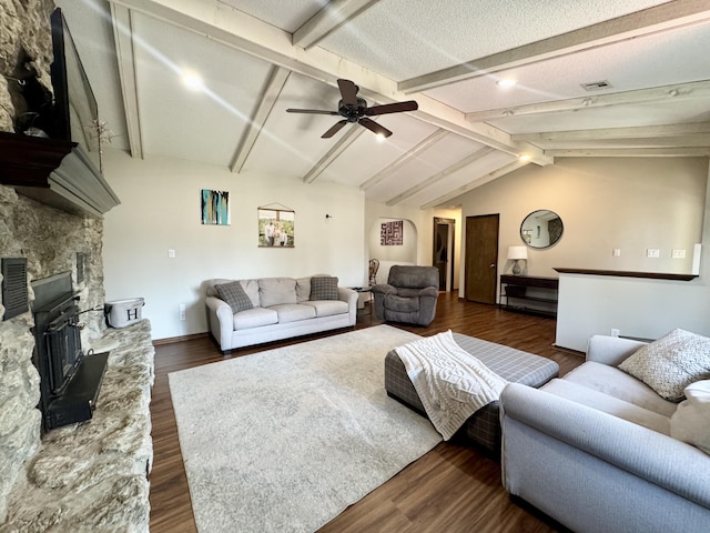 living area with dark wood-style floors, lofted ceiling with beams, a textured ceiling, and a ceiling fan