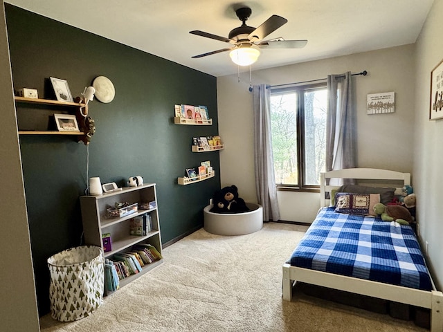 carpeted bedroom with baseboards and a ceiling fan