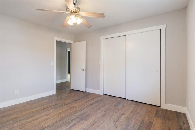unfurnished bedroom with a closet, baseboards, ceiling fan, and wood finished floors