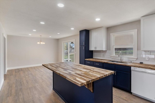 kitchen featuring a sink, white cabinets, light wood-type flooring, white dishwasher, and wood counters