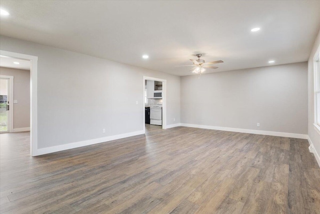 unfurnished living room featuring baseboards, wood finished floors, ceiling fan, and recessed lighting