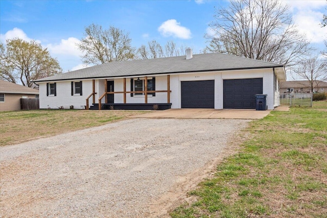 single story home with driveway, fence, a garage, a front lawn, and a porch
