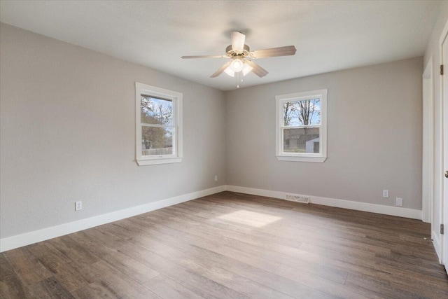 unfurnished bedroom with baseboards, visible vents, a ceiling fan, and wood finished floors