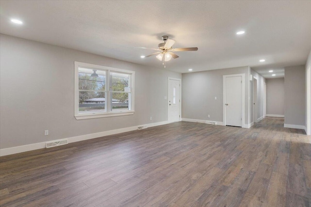 unfurnished living room with baseboards, visible vents, ceiling fan, recessed lighting, and dark wood-style flooring