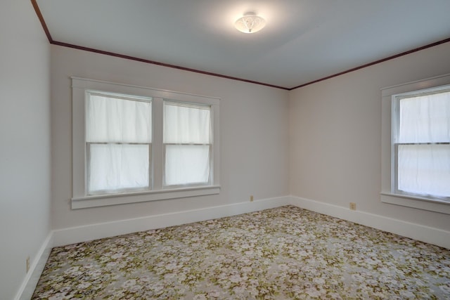 empty room with baseboards and ornamental molding