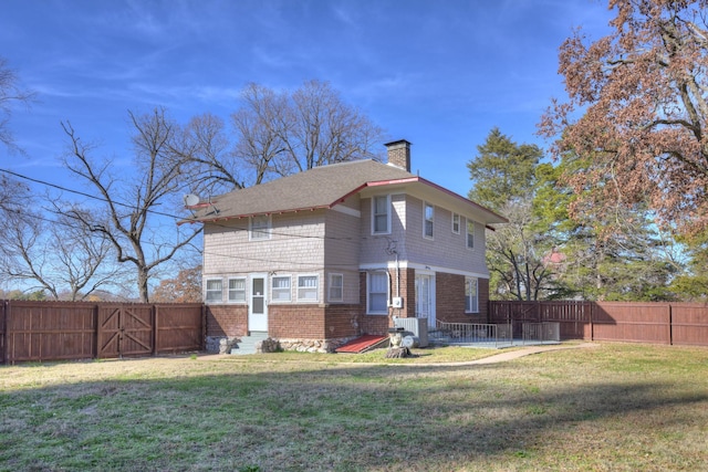 back of property featuring a fenced backyard, entry steps, a yard, and a chimney