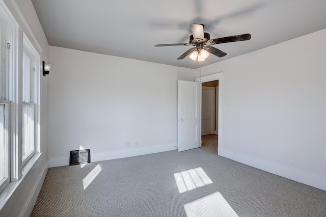 unfurnished room featuring baseboards, carpet floors, and ceiling fan