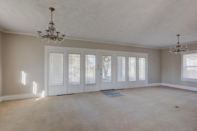 entrance foyer with light carpet, crown molding, french doors, and a chandelier