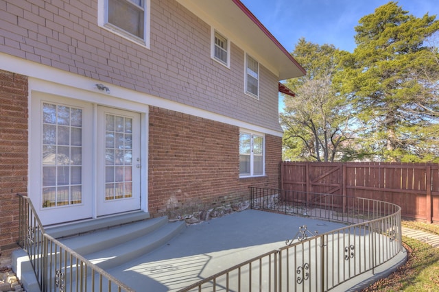 wooden deck with fence, entry steps, and a patio area