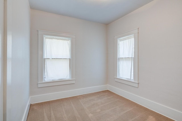 unfurnished room featuring baseboards and carpet floors
