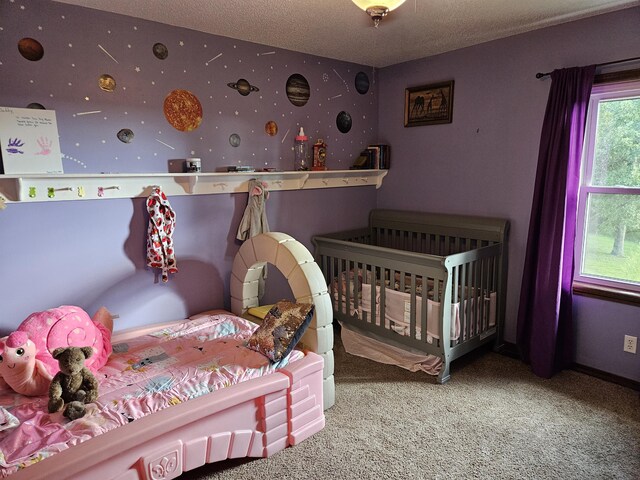 bedroom with carpet flooring, a textured ceiling, and wallpapered walls