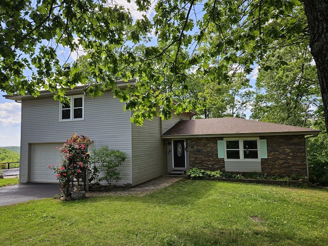 2489 Logan Ridge Rd, Ozark, MO 65721 - view of front of home with an attached garage, asphalt driveway, a front yard, and brick siding