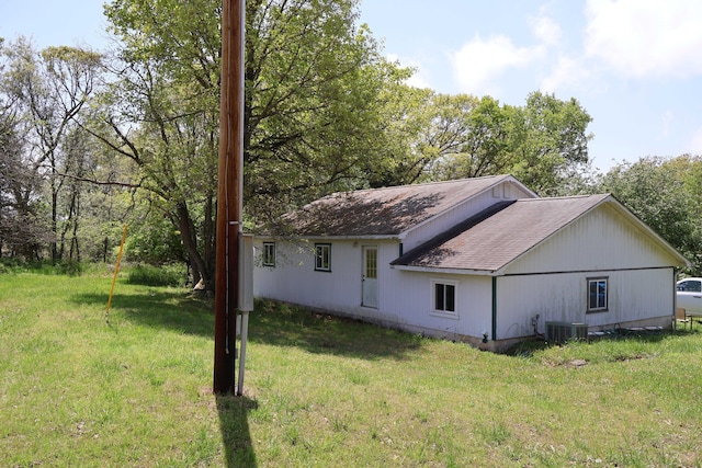 3987 County Road 2350, Pomona, MO 65789 - view of home's exterior featuring a shingled roof, cooling unit, and a lawn