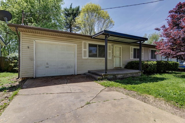 single story home featuring a garage, driveway, and a front yard