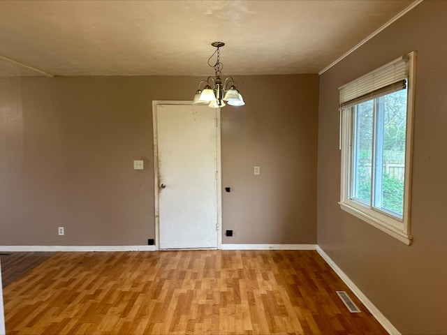 unfurnished dining area featuring light wood-style flooring, visible vents, and plenty of natural light