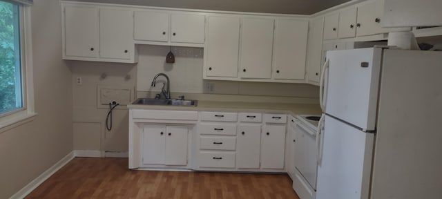 1022 E Mccanse St, Springfield, MO 65803 - kitchen featuring freestanding refrigerator, a sink, wood finished floors, and white cabinetry