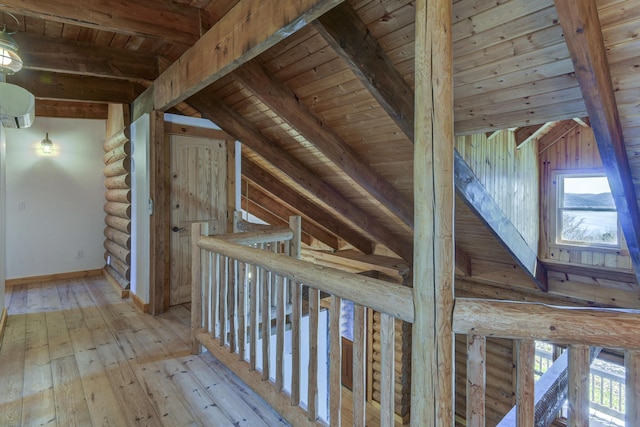 hall featuring beamed ceiling, wooden ceiling, and log walls