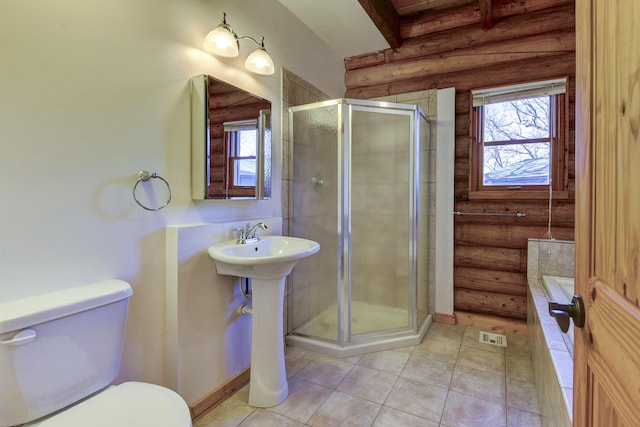 full bathroom featuring a stall shower, toilet, log walls, and a healthy amount of sunlight