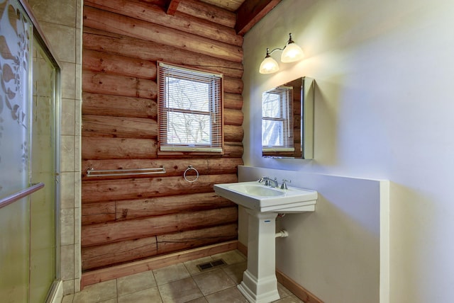 bathroom with tile patterned floors, visible vents, baseboards, and a shower stall
