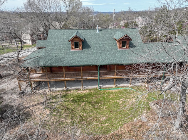 back of property featuring log siding and roof with shingles