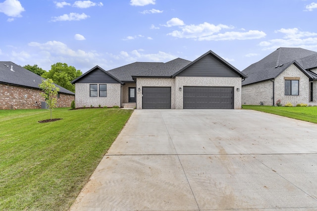 2117 N Silver Charm Ave, Springfield, MO 65802 - view of front of house with an attached garage, driveway, a front yard, and brick siding