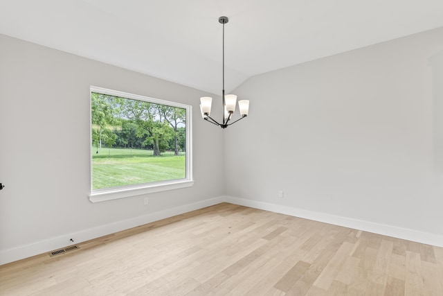 2117 N Silver Charm Ave, Springfield, MO 65802 - unfurnished room with light wood finished floors, a chandelier, and vaulted ceiling