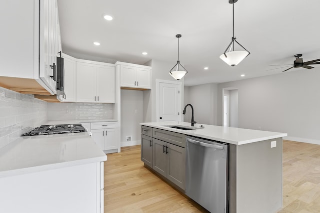 2117 N Silver Charm Ave, Springfield, MO 65802 - kitchen with appliances with stainless steel finishes, tasteful backsplash, recessed lighting, light countertops, and white cabinetry