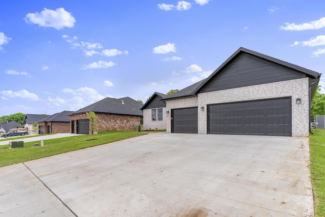 2117 N Silver Charm Ave, Springfield, MO 65802 - single story home featuring brick siding, a garage, driveway, and a front yard