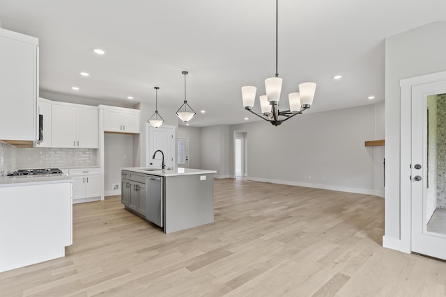 2117 N Silver Charm Ave, Springfield, MO 65802 - kitchen with dishwasher, light countertops, a chandelier, decorative backsplash, and recessed lighting