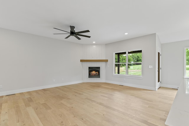2117 N Silver Charm Ave, Springfield, MO 65802 - unfurnished living room featuring light wood-style flooring, a fireplace, ceiling fan, and recessed lighting