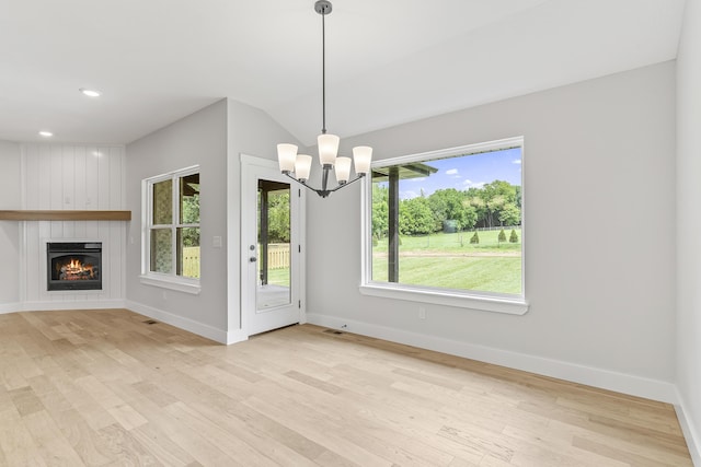 2117 N Silver Charm Ave, Springfield, MO 65802 - unfurnished dining area featuring wood finished floors, a chandelier, a fireplace, recessed lighting, and lofted ceiling