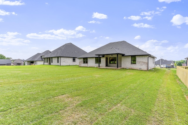 2117 N Silver Charm Ave, Springfield, MO 65802 - back of property featuring brick siding, roof with shingles, and a patio area