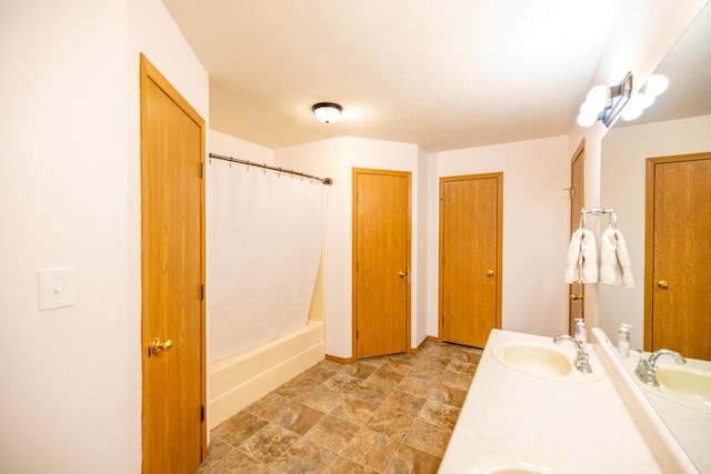 919 S Central Ave, Marionville, MO 65705 - bathroom with double vanity, a textured ceiling, a sink, and a shower with curtain