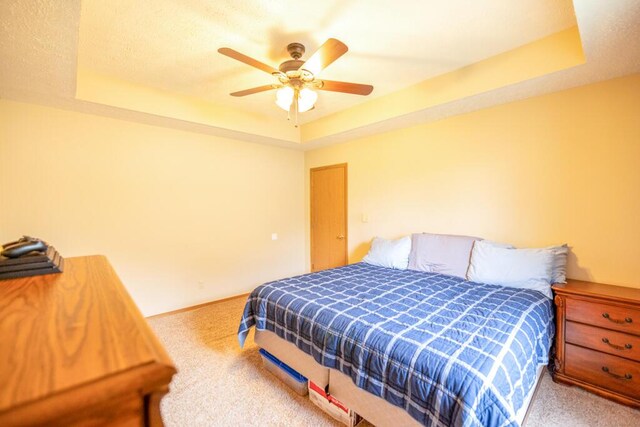919 S Central Ave, Marionville, MO 65705 - carpeted bedroom featuring baseboards, a ceiling fan, a textured ceiling, and a raised ceiling