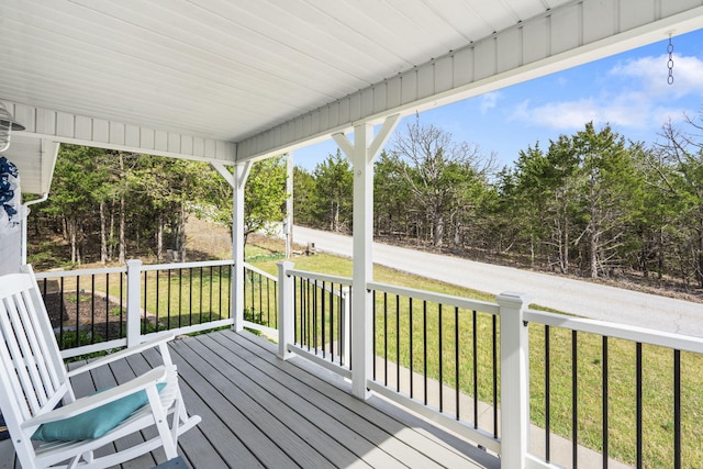deck featuring a porch and a lawn