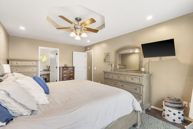 bedroom with baseboards, recessed lighting, and connected bathroom