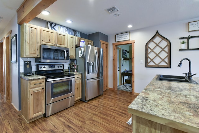 1428 Acacia Club Rd, Hollister, MO 65672 - kitchen featuring appliances with stainless steel finishes, wood finished floors, a sink, and visible vents