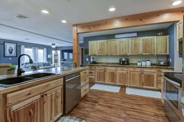 1428 Acacia Club Rd, Hollister, MO 65672 - kitchen with visible vents, a sink, appliances with stainless steel finishes, dark wood-type flooring, and backsplash