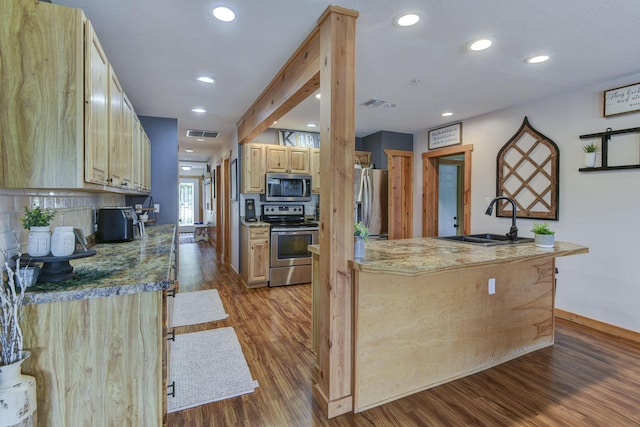 1428 Acacia Club Rd, Hollister, MO 65672 - kitchen featuring tasteful backsplash, appliances with stainless steel finishes, wood finished floors, a sink, and baseboards