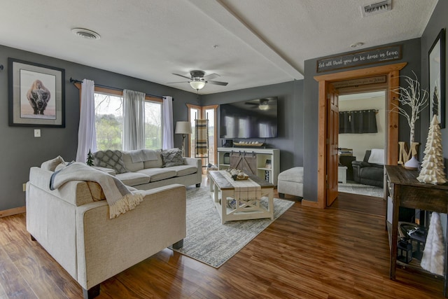 1428 Acacia Club Rd, Hollister, MO 65672 - living area with visible vents, a ceiling fan, and wood finished floors