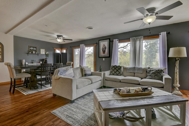 1428 Acacia Club Rd, Hollister, MO 65672 - living area with wood finished floors, ceiling fan, baseboards, and visible vents