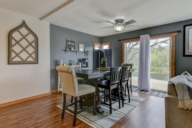 1428 Acacia Club Rd, Hollister, MO 65672 - dining area featuring wood finished floors, ceiling fan, and baseboards