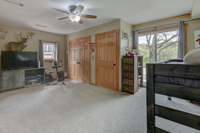 1428 Acacia Club Rd, Hollister, MO 65672 - carpeted bedroom featuring visible vents, multiple closets, and ceiling fan