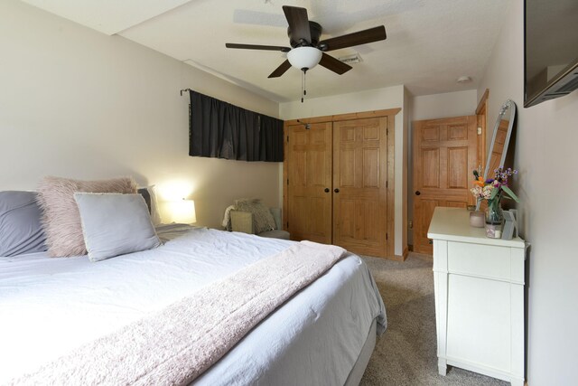 1428 Acacia Club Rd, Hollister, MO 65672 - bedroom with a closet, a ceiling fan, and light carpet
