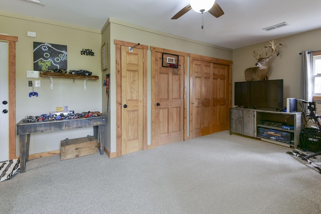 1428 Acacia Club Rd, Hollister, MO 65672 - carpeted living room with visible vents and a ceiling fan